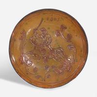 A glazed sgraffito-decorated redware plate depicting a horse and cavalier attributed to Jacob Medinger (1856-1932), Montgomery County, PA