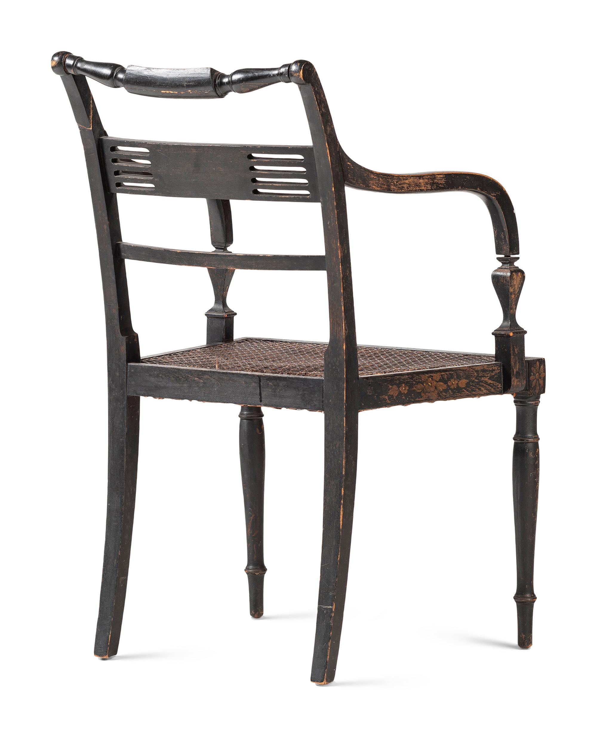 A Classical Black and Gilt Decorated Cane-Upholstered Armchair