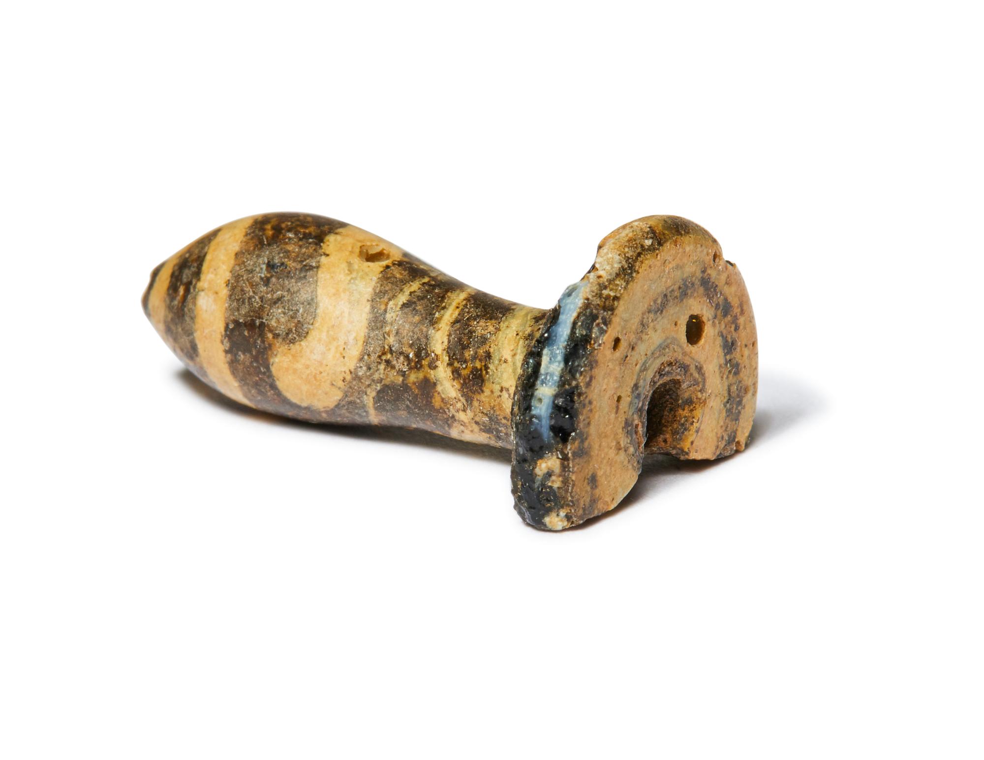 An Egyptian Charcoal and White Glass Ear Plug