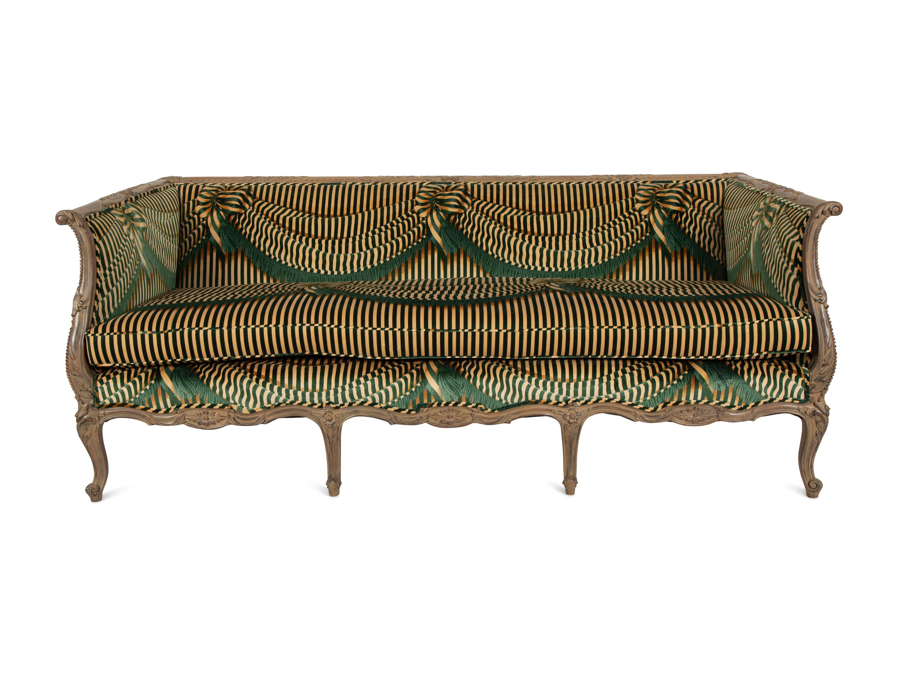 A Louis XV Style Carved and Stained Mahogany Sofa