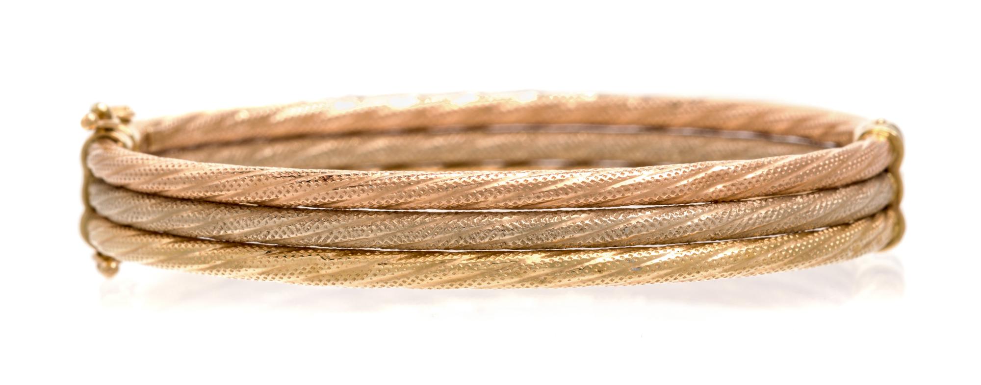 A 14 Karat Tricolor Gold Bangle Bracelet. 7.30 dwts.