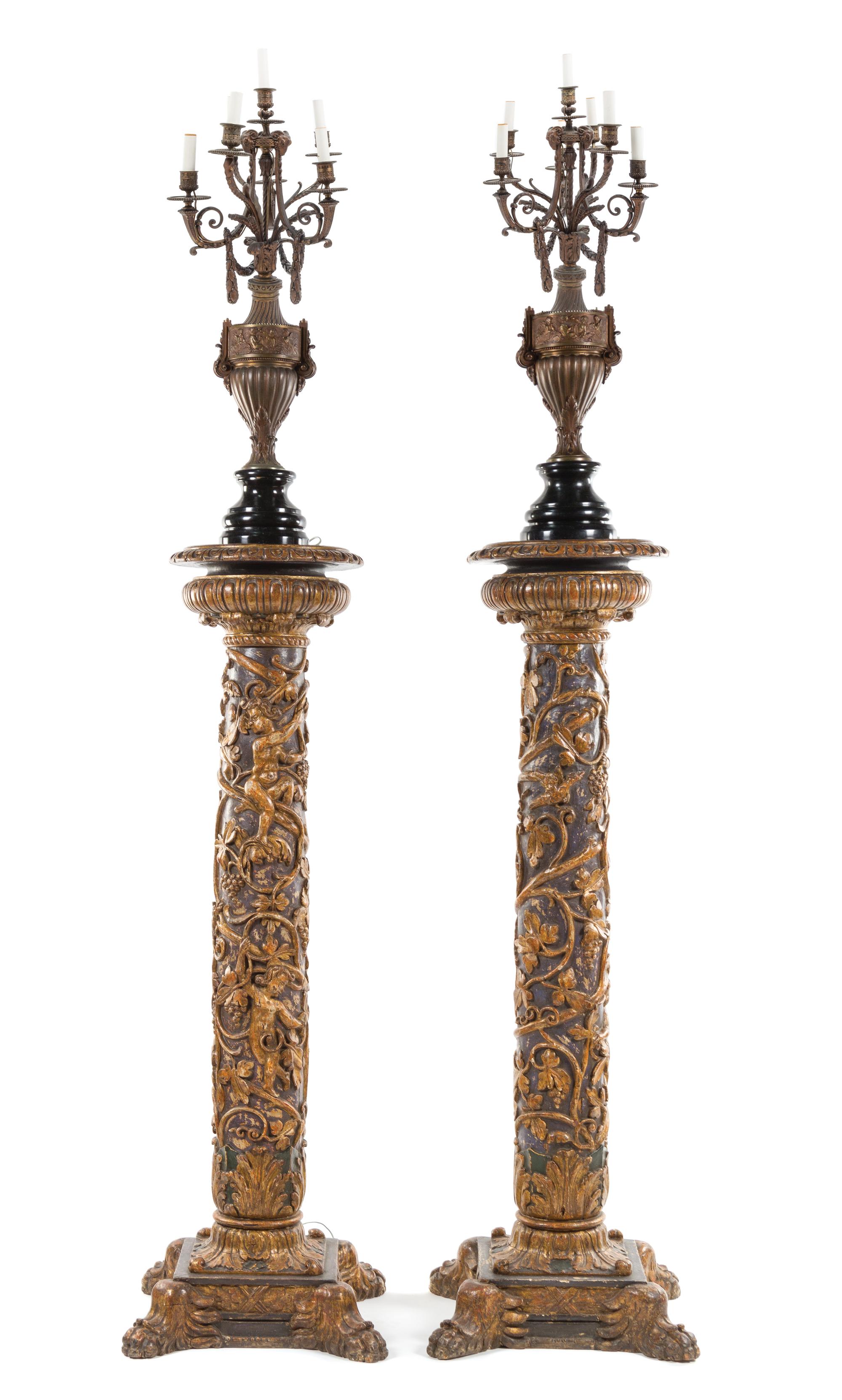 A Pair of Italian Baroque Style Carved and Giltwood Pedestals Height 79 1/2 inches (including later urn mount).