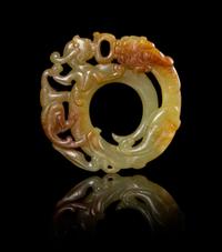 A Celadon and Russet Jade Plaque Diameter 2 1/8 inches.