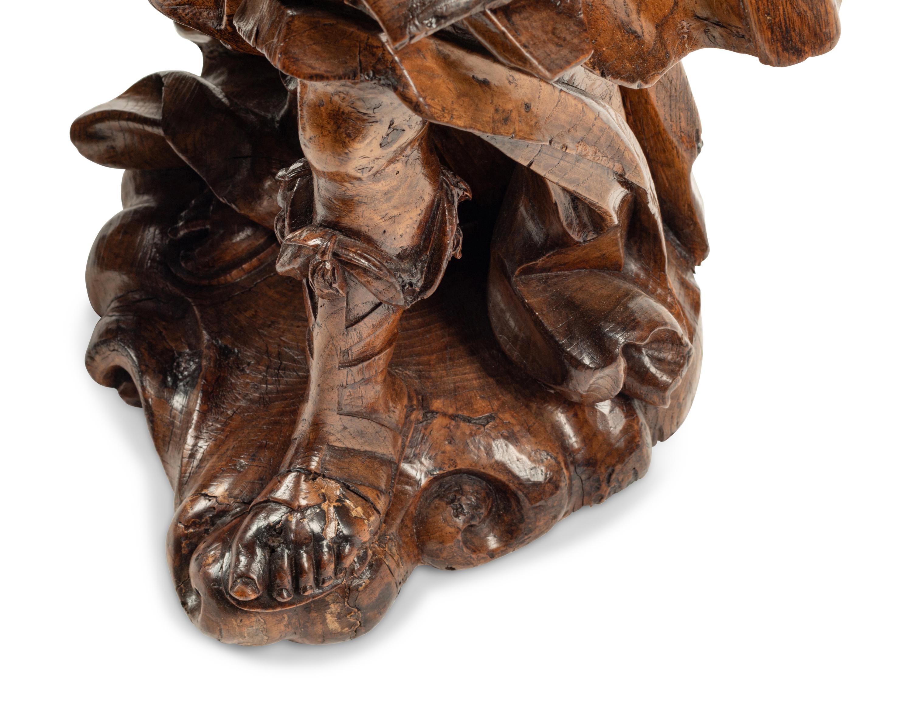 A Pair of Continental Carved Wood Figural Prickets