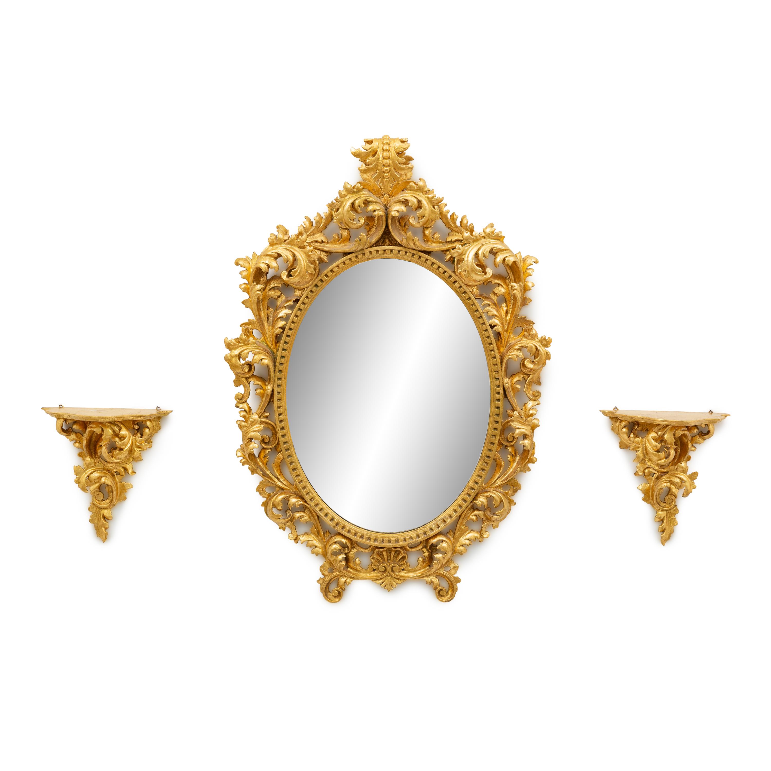 An Italian Rococo Style Carved Giltwood Oval Mirror and a Pair of Wall Brackets