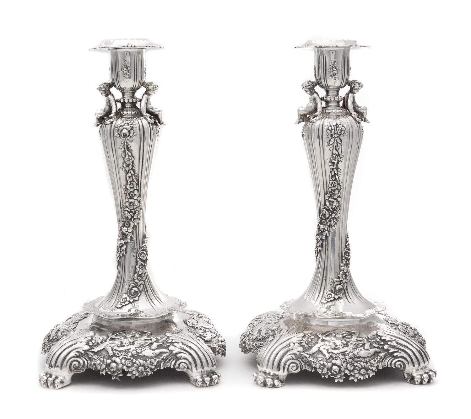 A Pair of American Silver Candlesticks, Tiffany & Co., New York, Circa 1900, each fluted urn form candle cup worked to show floral spra
