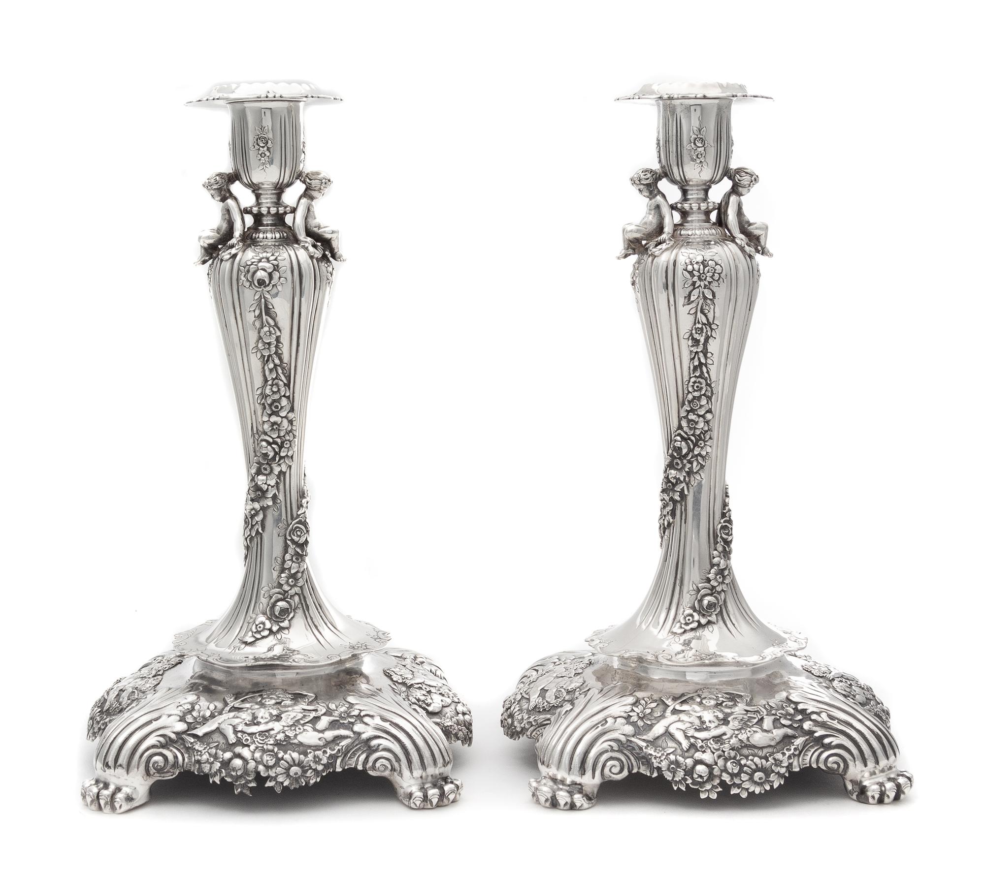 A Pair of American Silver Candlesticks, Tiffany & Co., New York, Circa 1900, each fluted urn form candle cup worked to show floral spra