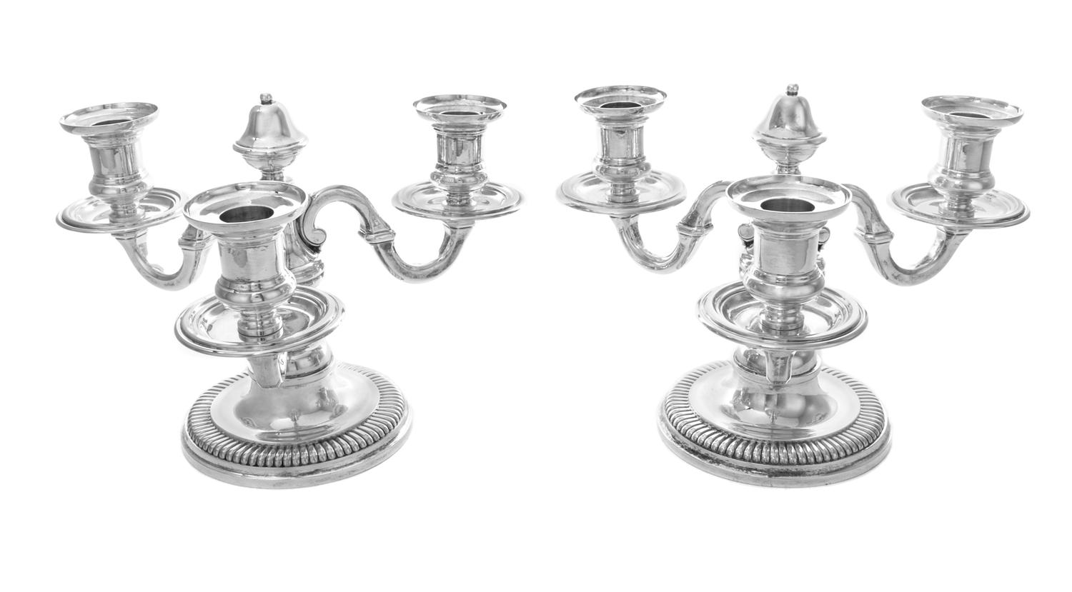 A Pair of French Silver Three-Light Candelabra, Emile Puiforcat, Paris, each having an undulating stem issuing scrolled candle arms and