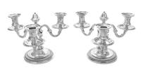 A Pair of French Silver Three-Light Candelabra, Emile Puiforcat, Paris, each having an undulating stem issuing scrolled candle arms and