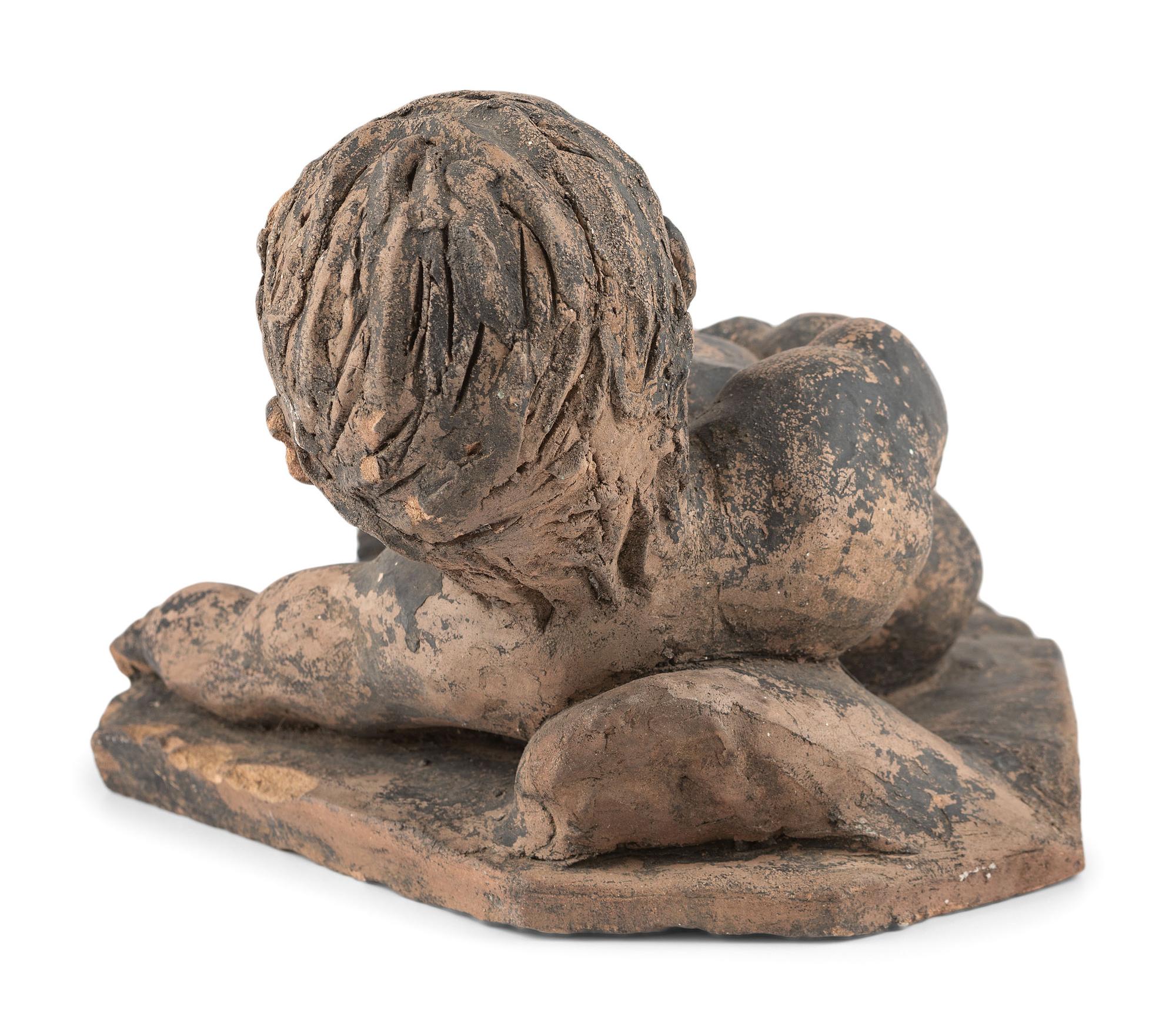 A Clay Roof Tile of a Reclining Baby