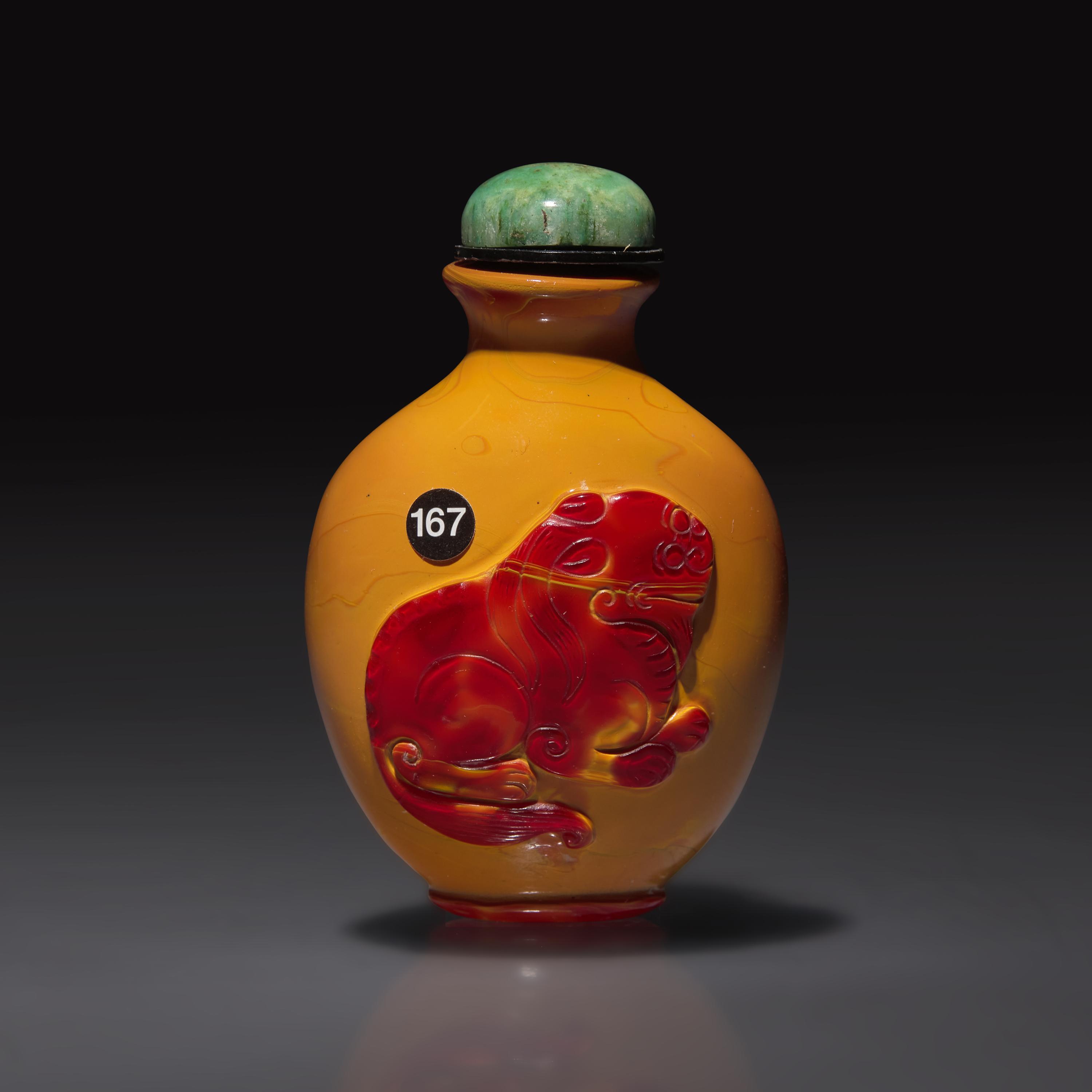 A Chinese Carved "Realgar" Glass "Horse and Lion" Snuff Bottle, Qing Dynasty, 19th Century — 清晚期 仿雄黃地套紅料動物圖鼻煙壺