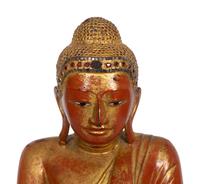 A Burmese Gilt and Red Lacquered Bronze Seated Buddha