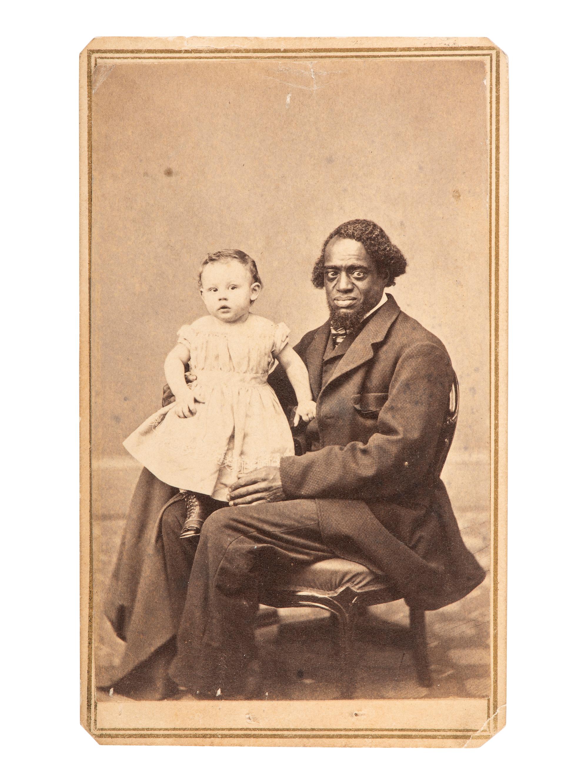 [EARLY PHOTOGRAPHY]. CDV of a formerly enslaved man holding a white child. Hudson, NY: F. Forshew.
