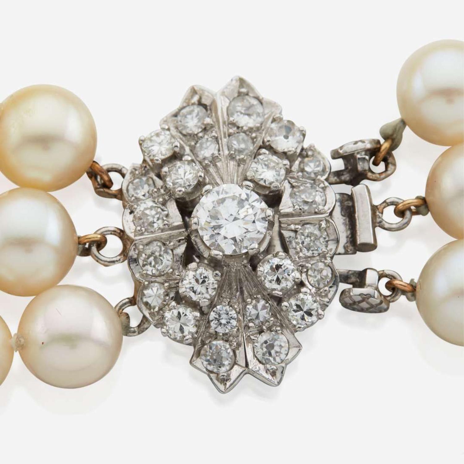 A cultured pearl, diamond, and platinum necklace with similar ear clips