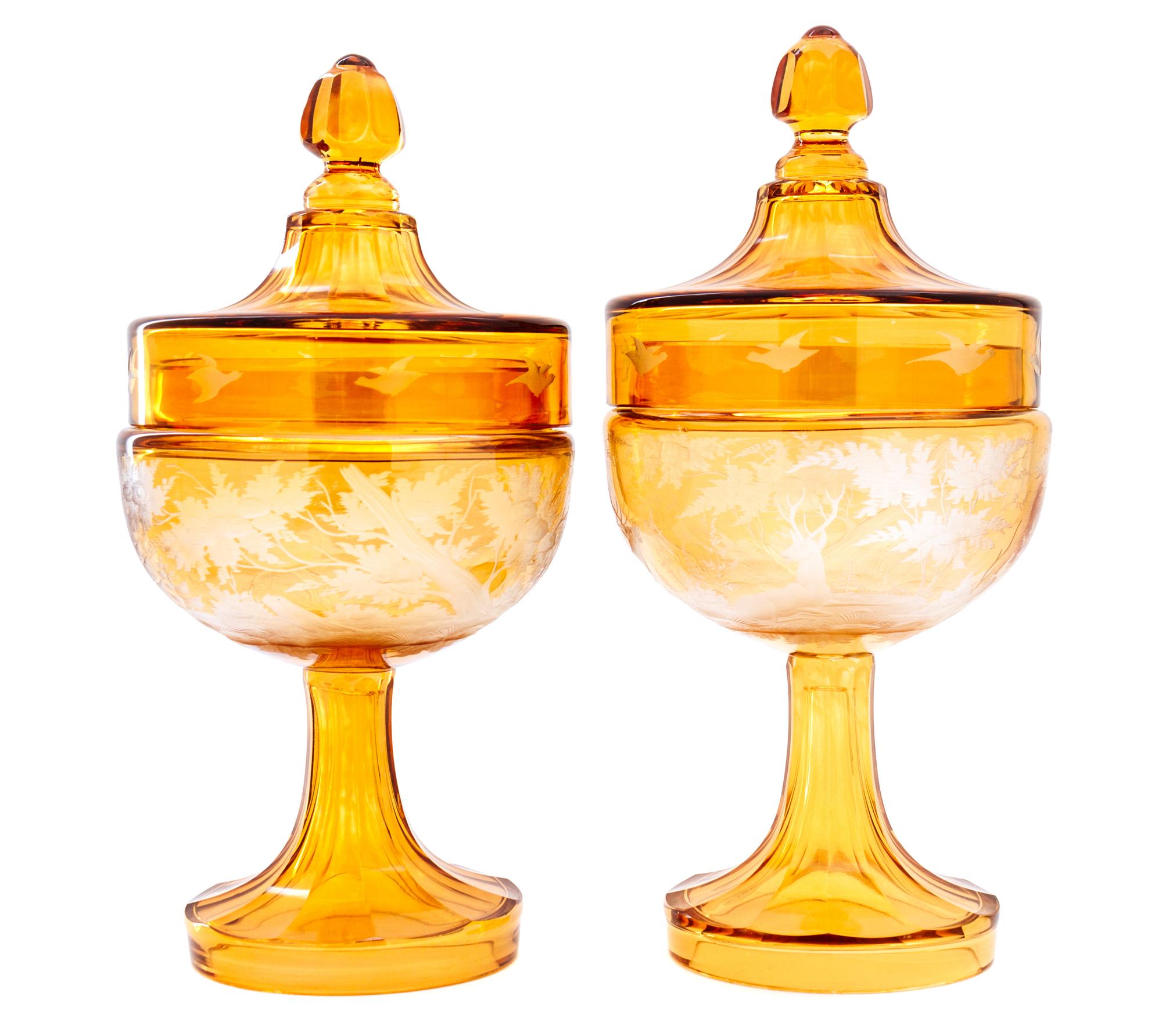 A Pair of Bohemian Etched Amber Glass Covered Urns Height 11 1/4 inches. — 20TH CENTURY