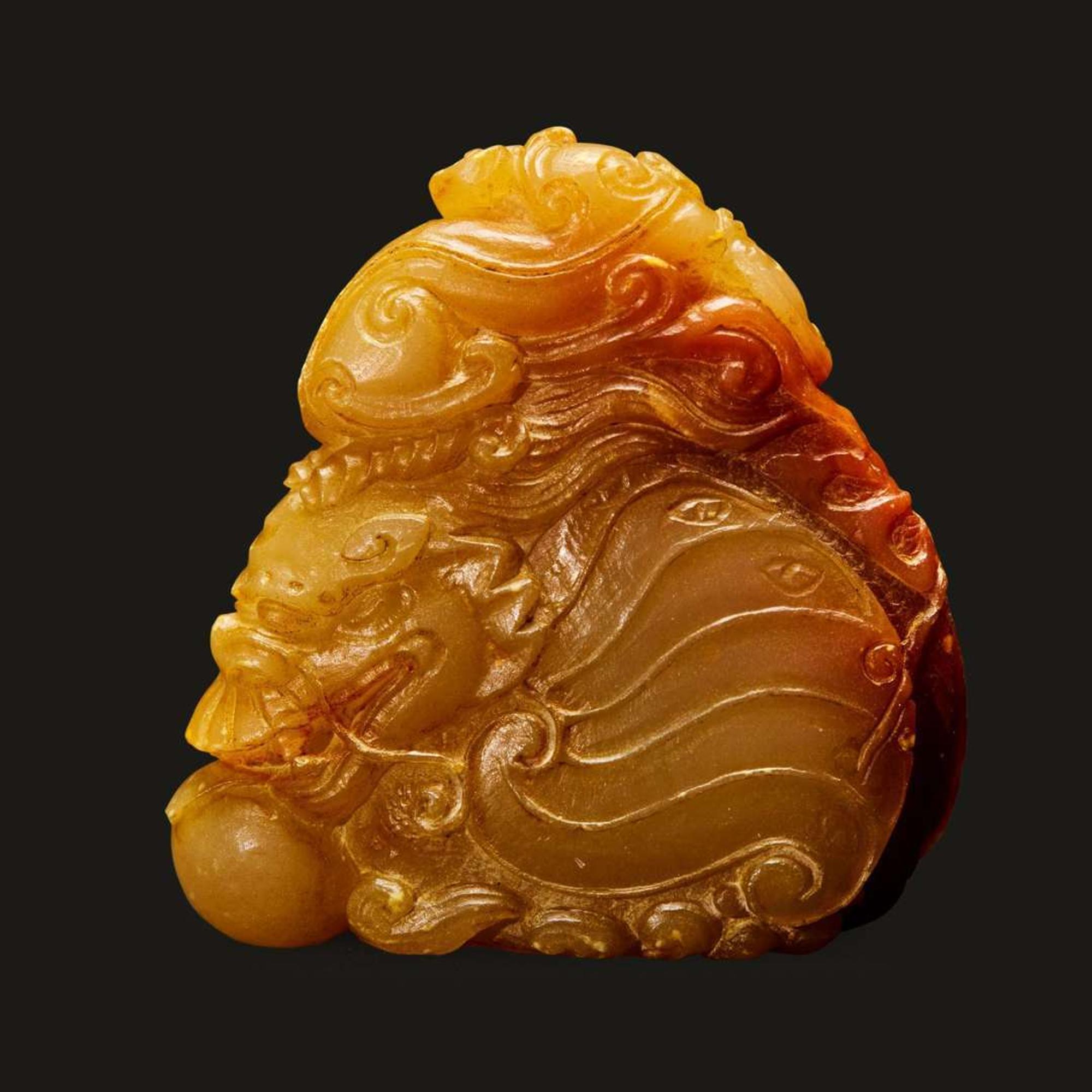 A finely-carved Chinese small yellow and russet soapstone dragon-fish, qilong, and pearl group 壽山石雕小把件