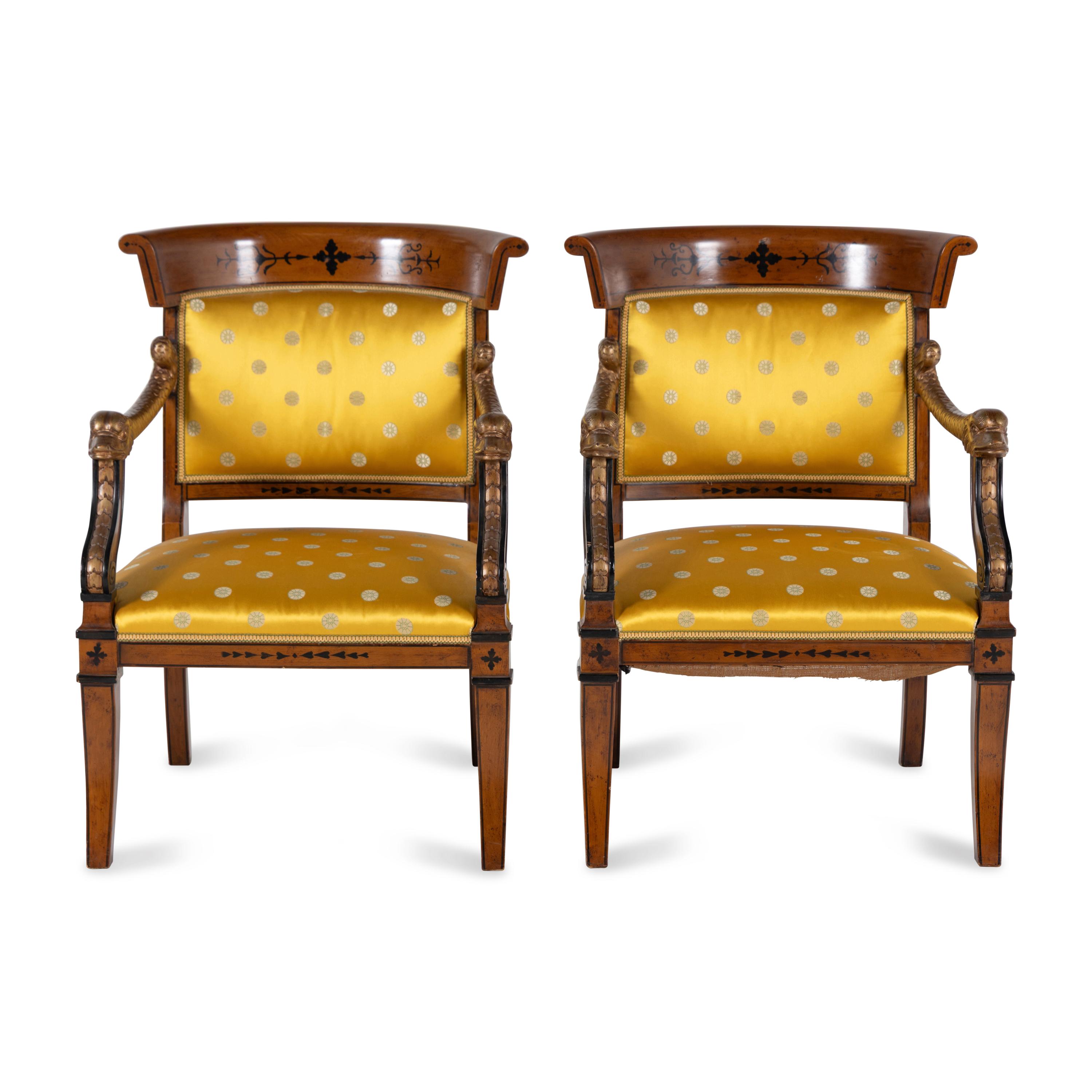 A Pair of Charles X Style Parcel-Gilt and Part Ebonized Armchairs
