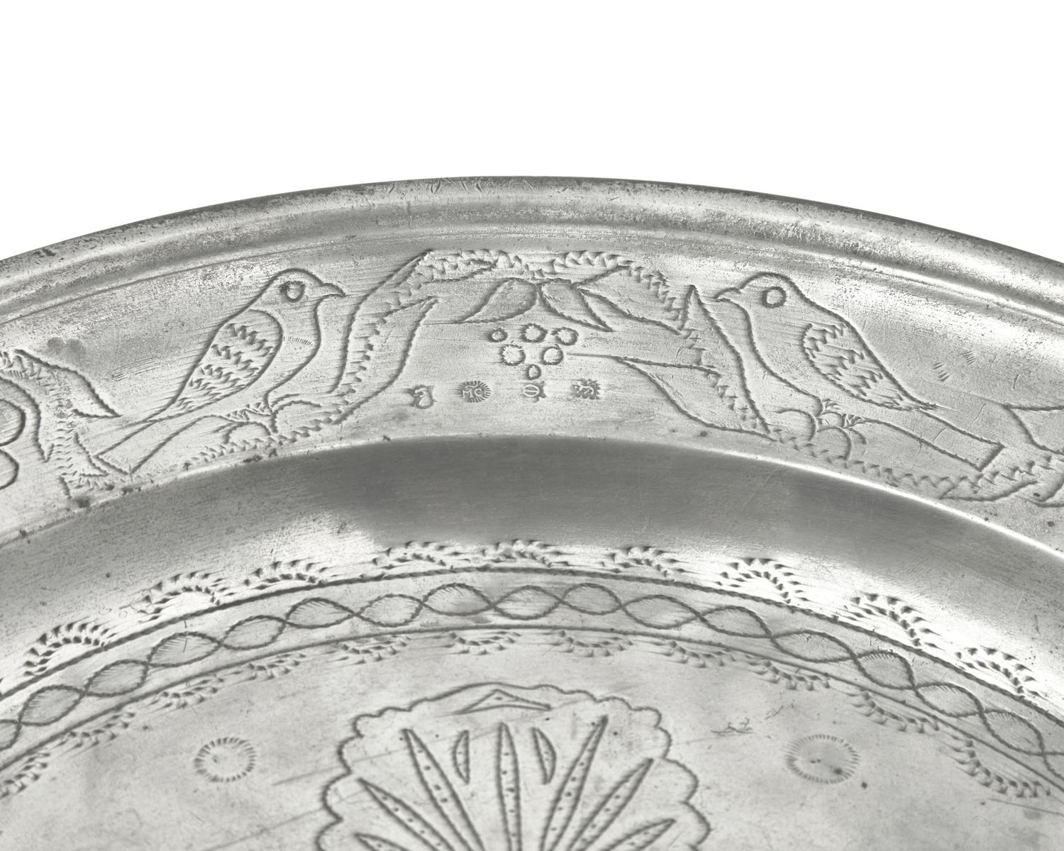 A Matched Pair of French Wriggle-Work Engraved Pewter Chargers, by M. Chocquell, Bergues, France, Circa 1750