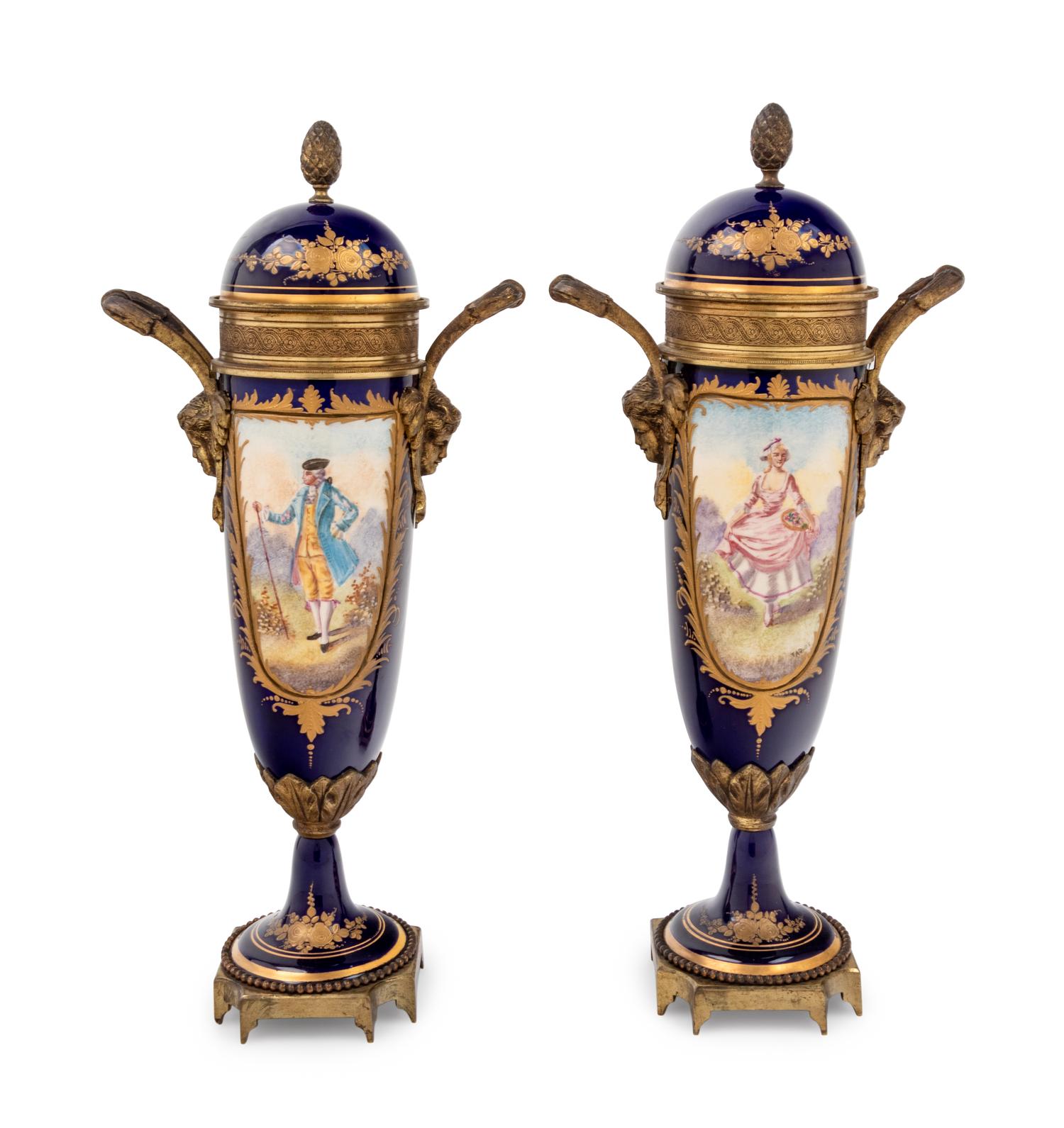 A Pair of Sèvres Style Gilt Metal Mounted Painted and Parcel Gilt Porcelain Urns
