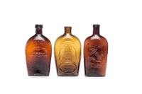 Three Molded Glass Amber Flasks
