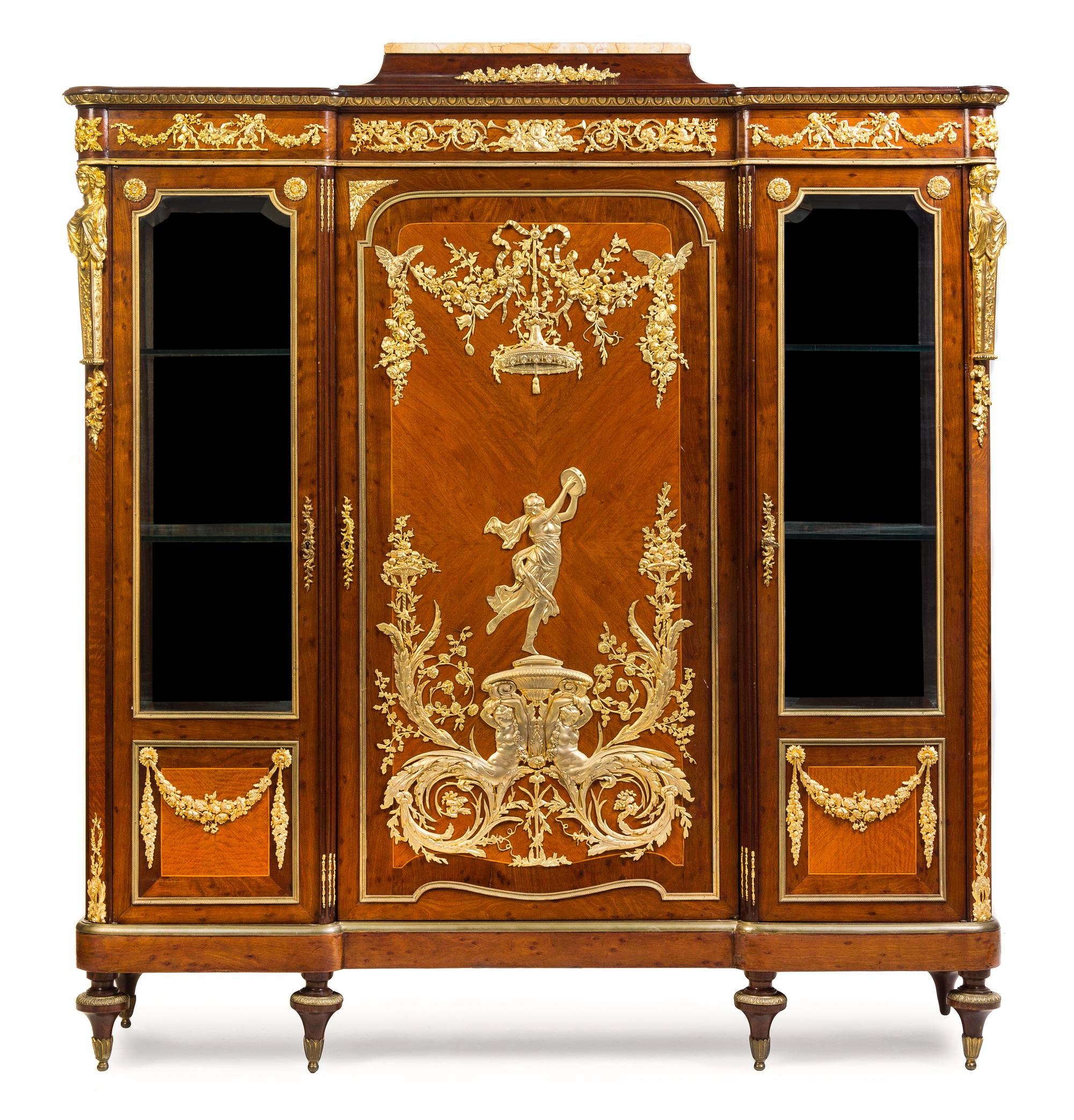 A Louis XVI Style Gilt Bronze Mounted Mahogany and Fruitwood Vitrine Cabinet Height 62 1/2 x width 57 1/2 x depth 16 1/2 inches. — ATTRIBUTED TO FRANCOIS LINKE, PARIS, CIRCA 1900