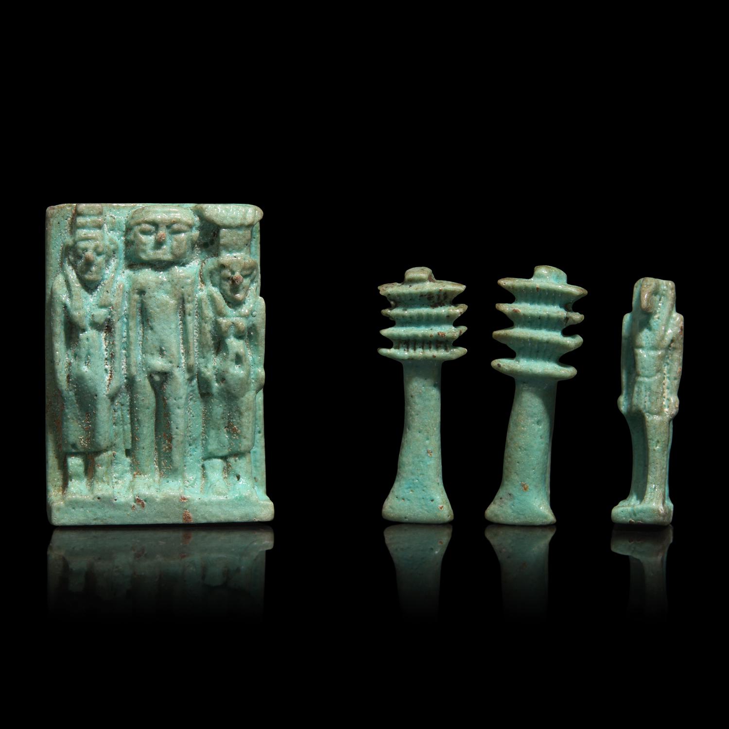 An Egyptian Faience Amulet with the Osirian Triad, two Djed Pillars, and a Thoth Amulet