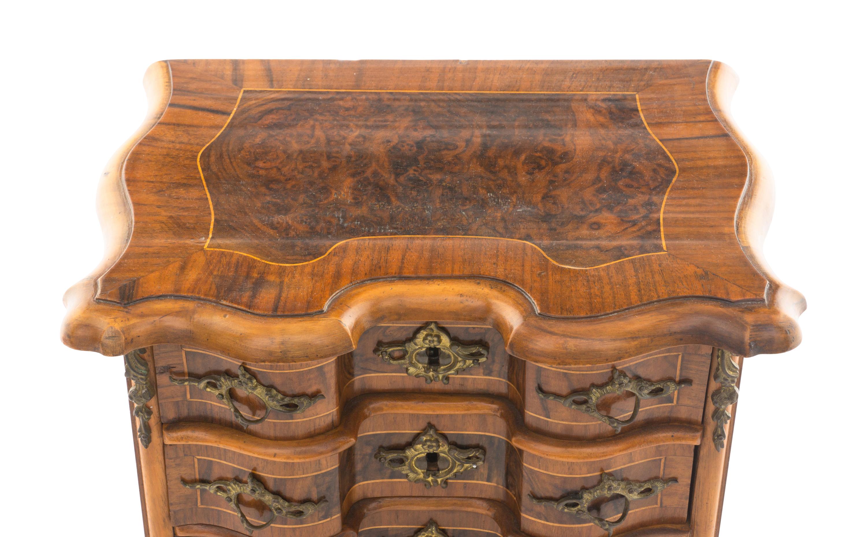 A Louis XV Style Walnut and Kingwood Diminutive Chest of Drawers
