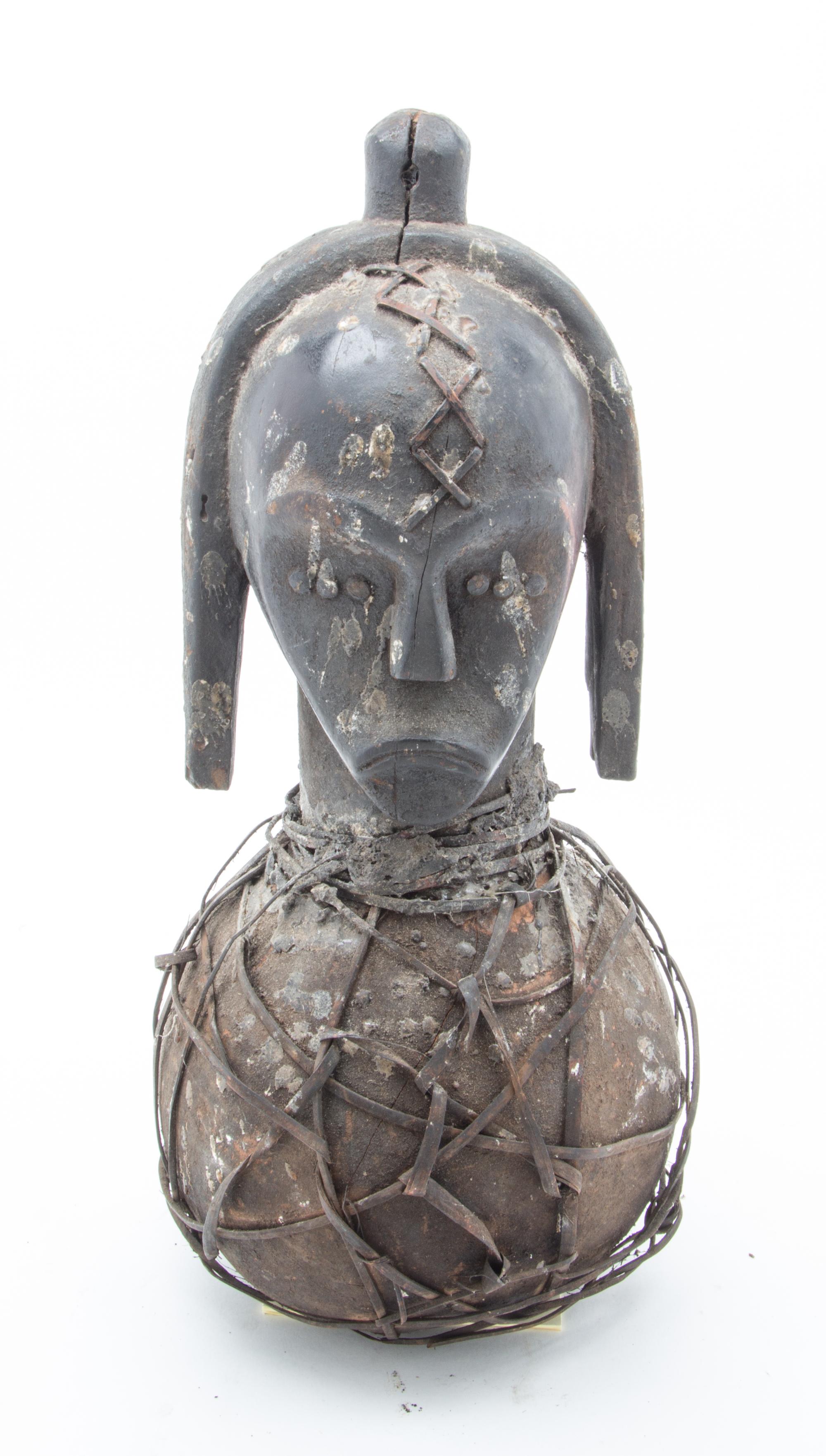 An Ethnographic Carved Wood and Metal Figure Height 19 3/4 inches.