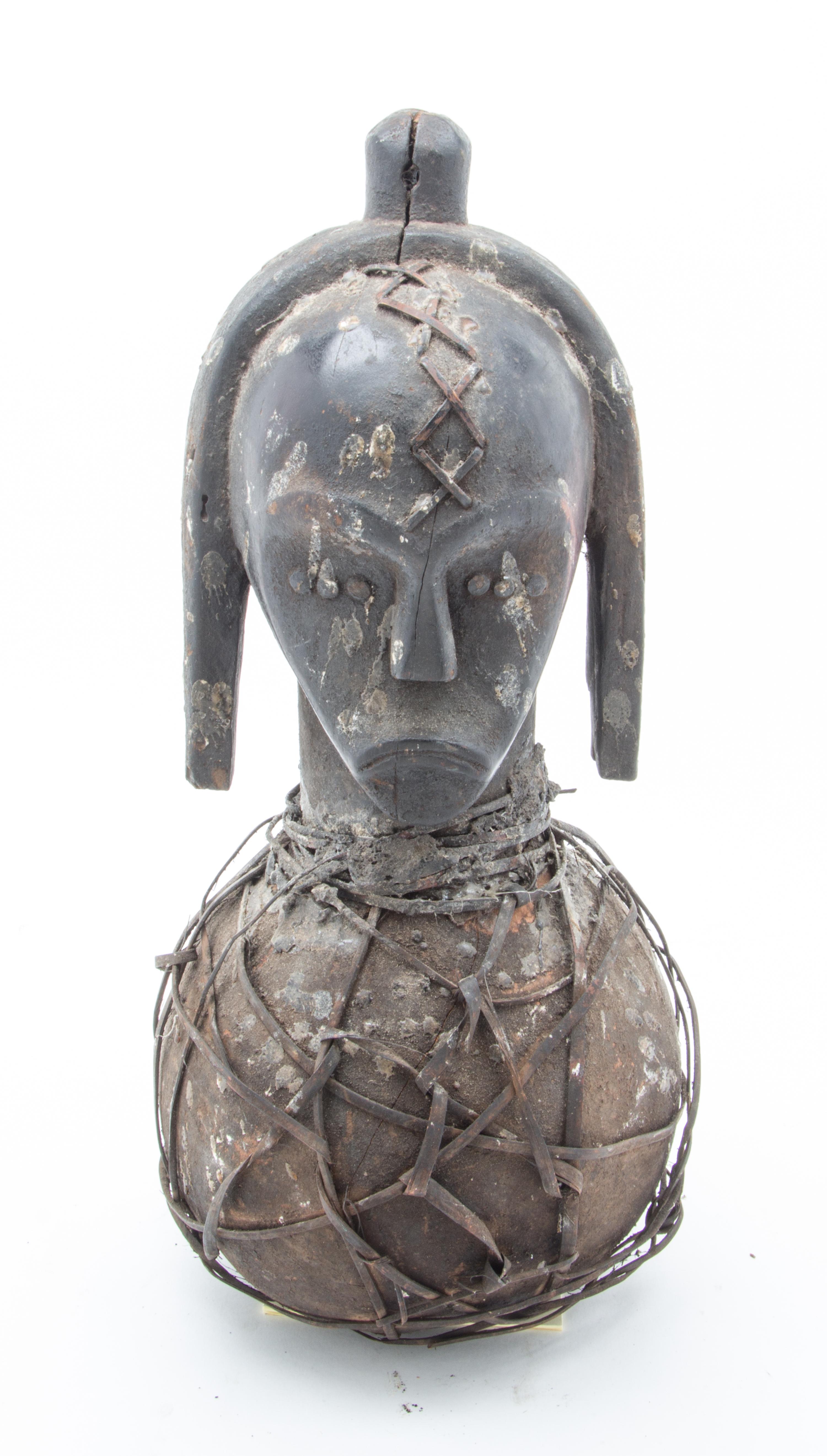 An Ethnographic Carved Wood and Metal Figure Height 19 3/4 inches.