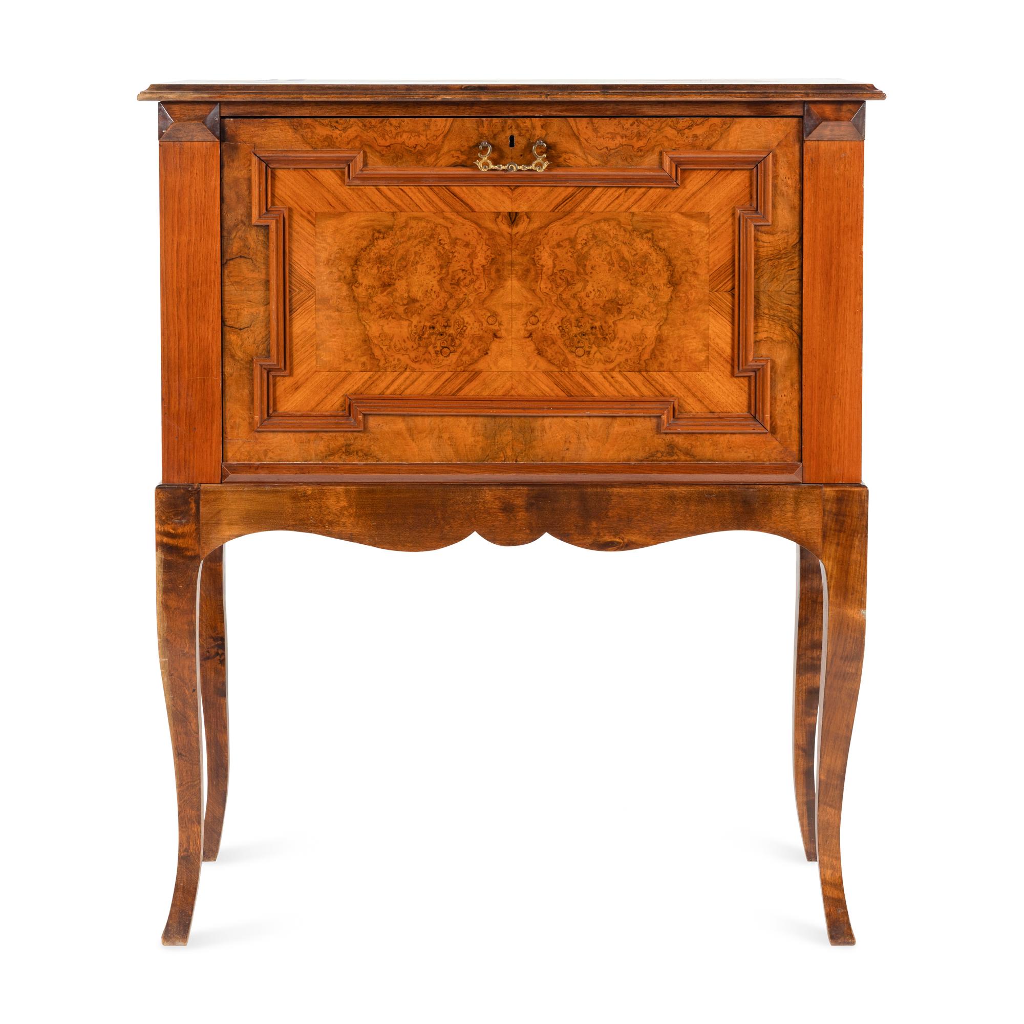 A Continental Carved and Figured Walnut Bureau