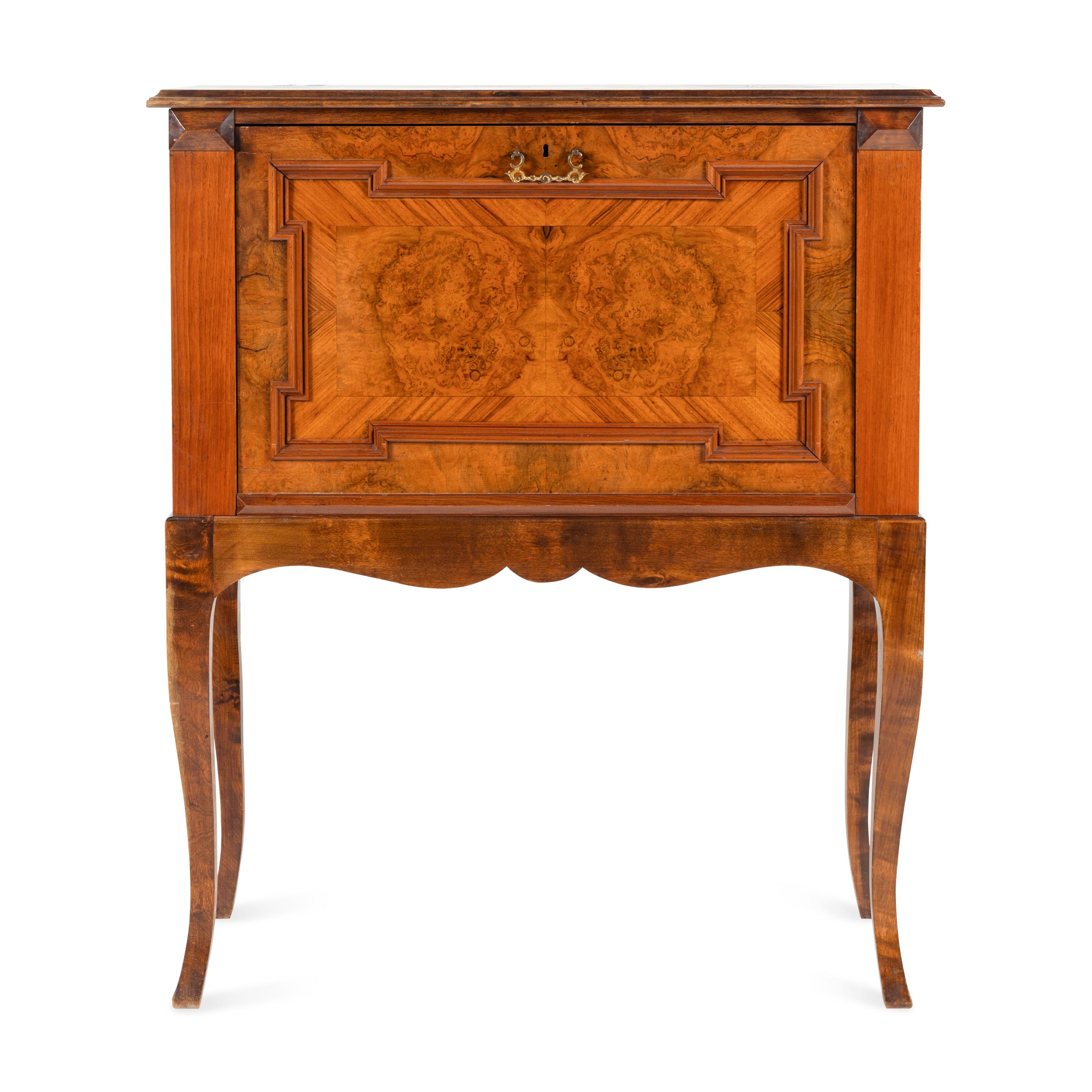 A Continental Carved and Figured Walnut Bureau