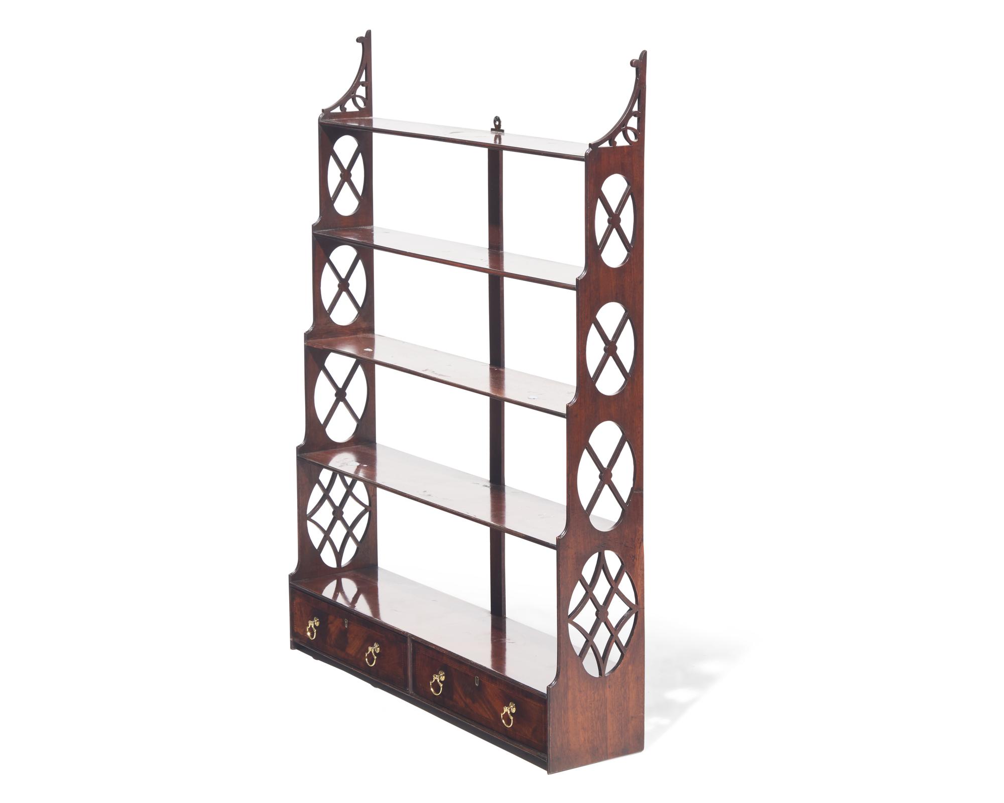 A George III fret-carved and inlaid mahogany hanging wall shelf, circa 1785