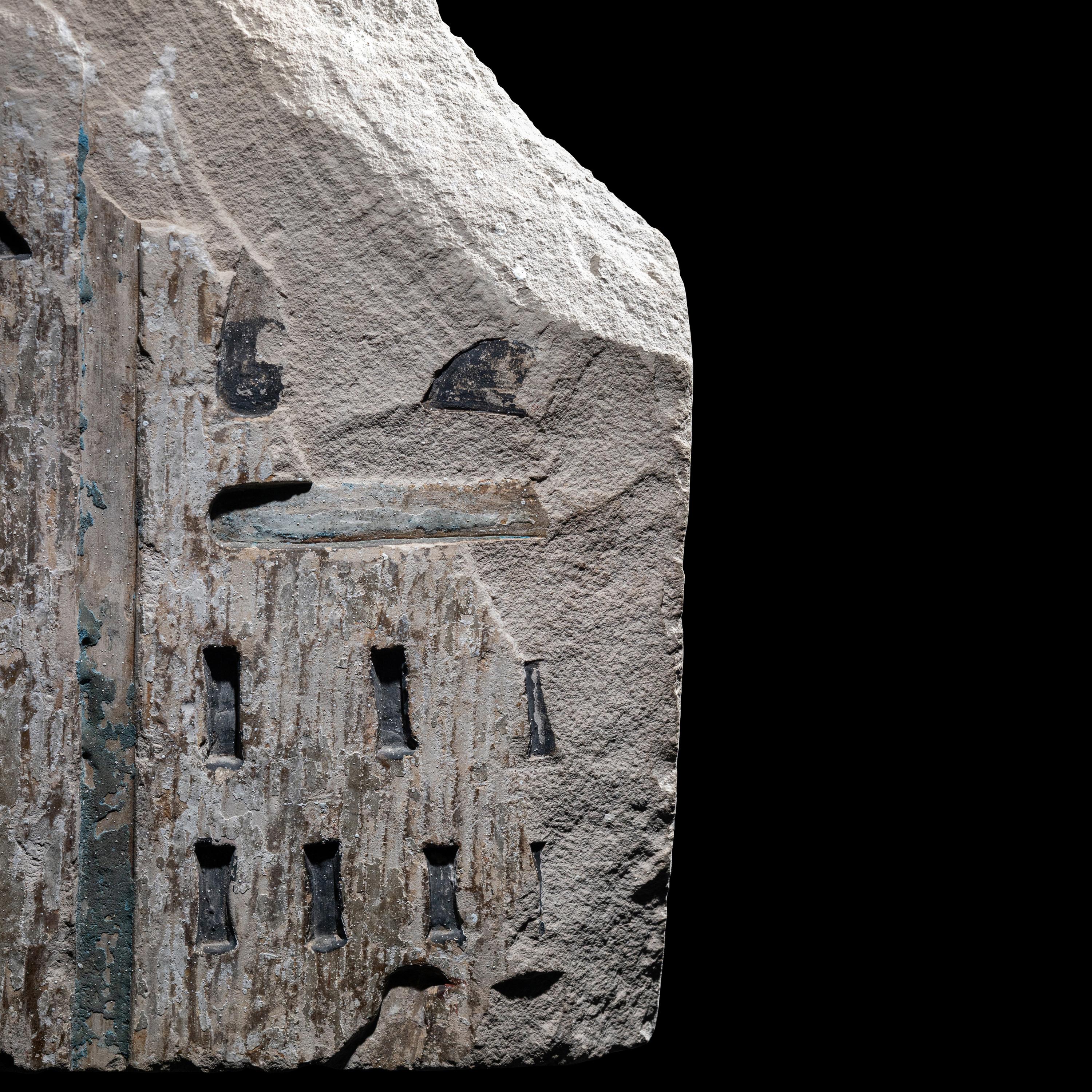 An Egyptian Polychrome Limestone Relief Fragment