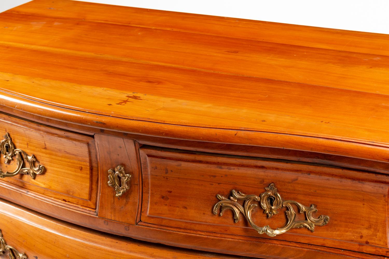 A French Provincial Walnut Bombe Commode