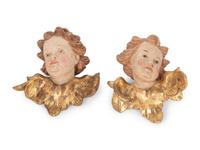 A Pair of Continental Painted and Parcel Gilt Putto Masks