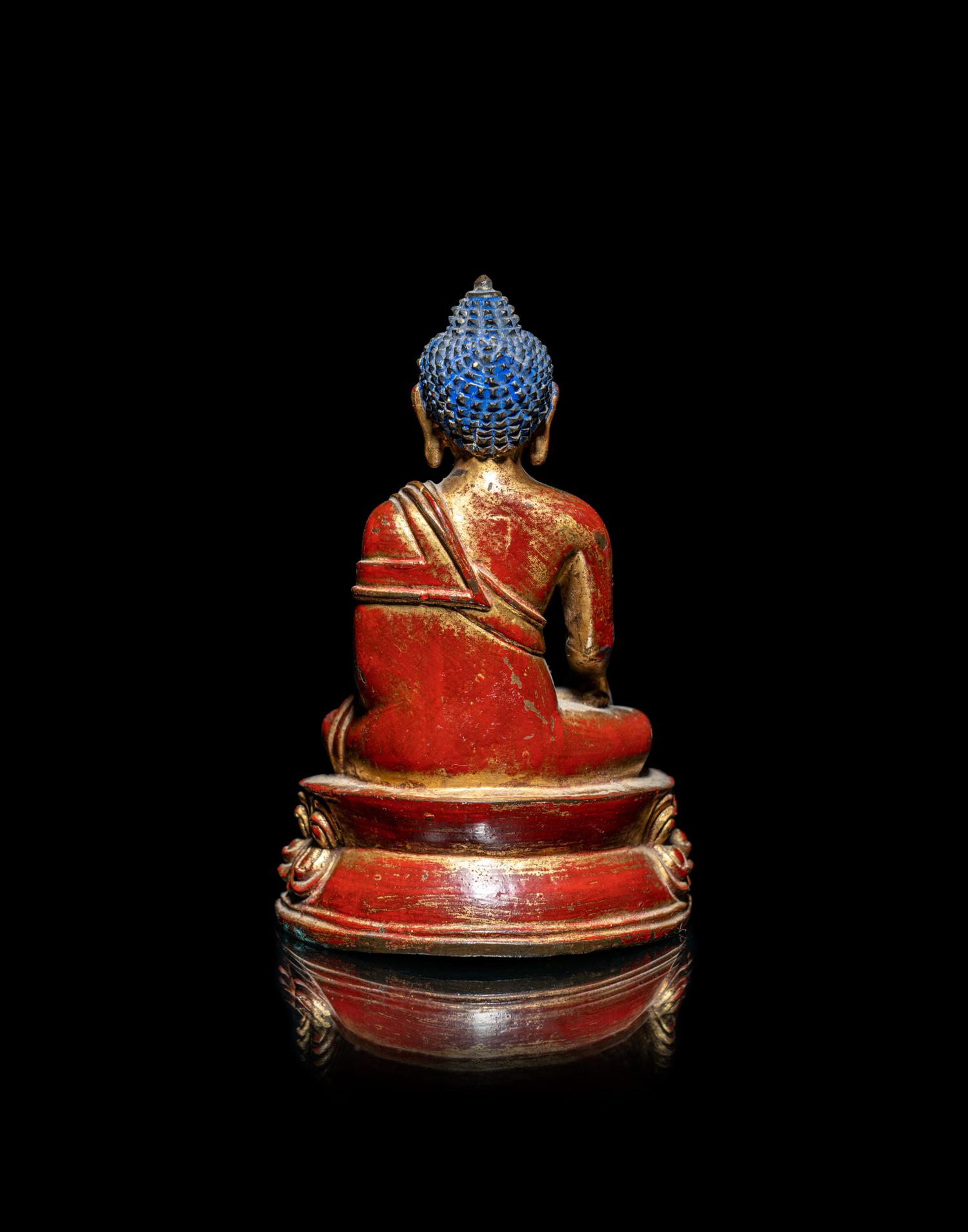 A Tibetan/Nepalese Gilt and Red Lacquered Bronze Figure of Buddha