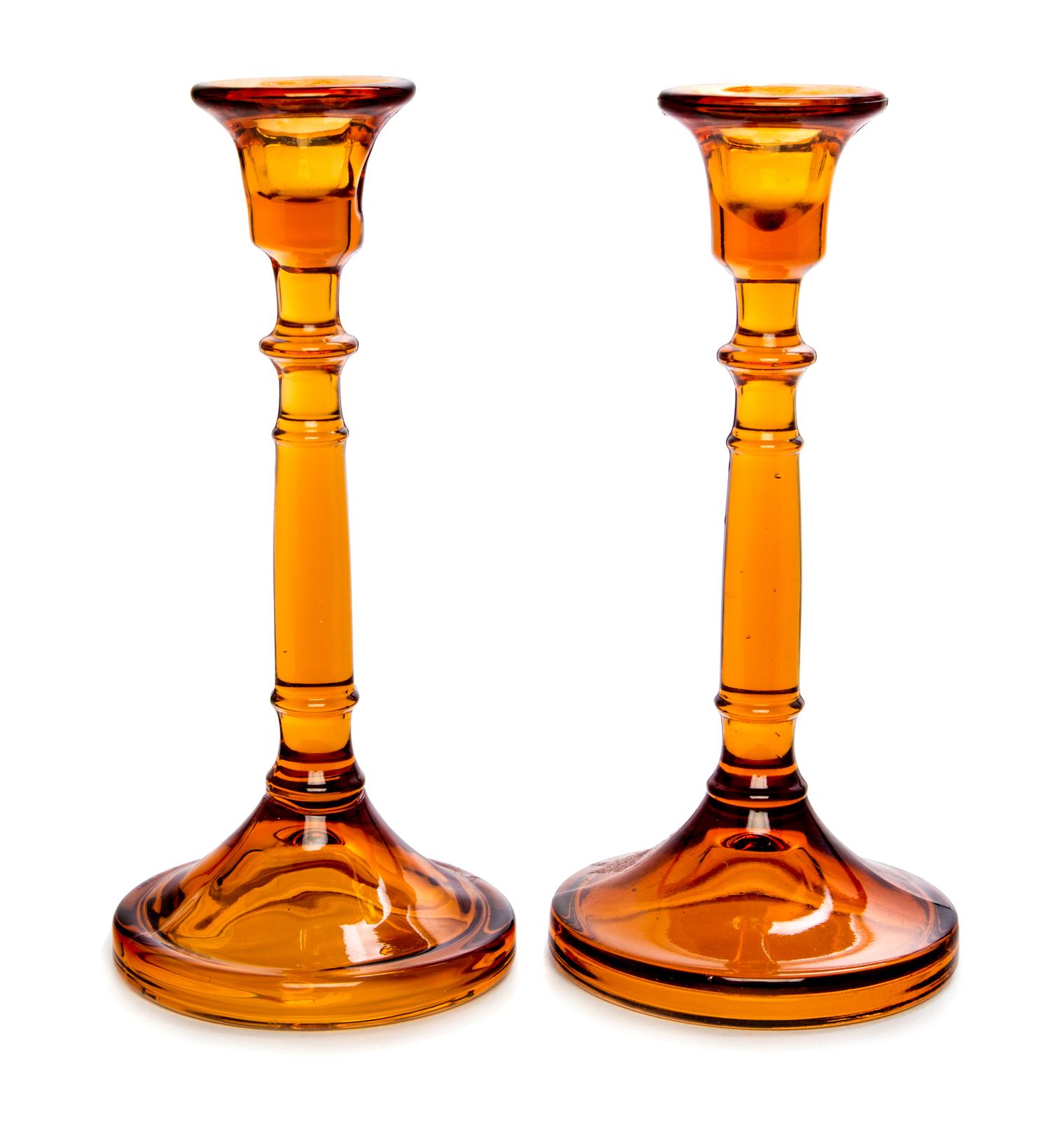 A Pair of Amber Glass Candlesticks Height 8 3/4 inches.