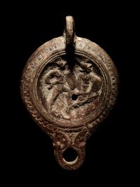 A Roman Terracotta Oil Lamp with Gladiators
