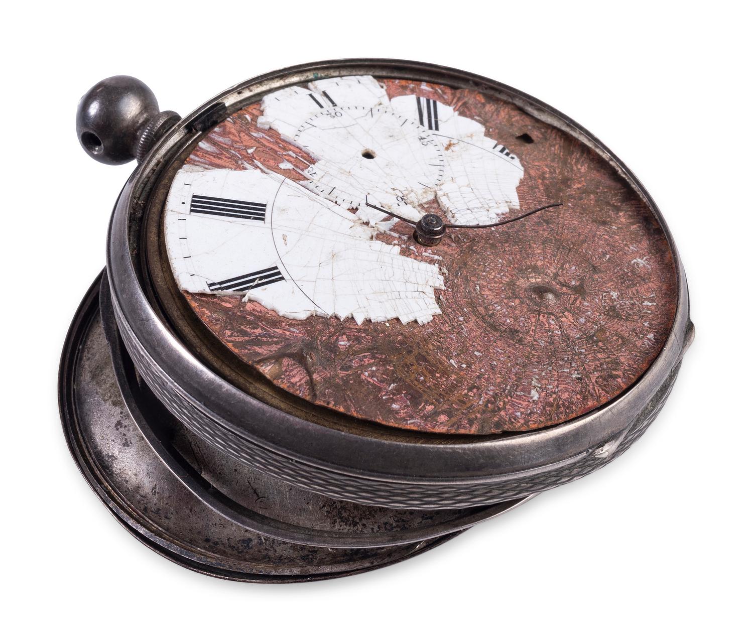 Corporal William L. Miller, Company G, 7th Indiana Volunteers. Bullet-struck pocket watch carried at the Battle of the Wilderness, which saved his life, with original bullet that almost ended it. May 1864.