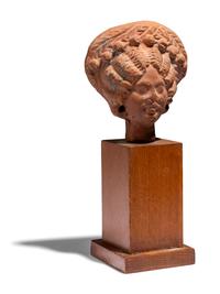 An Egyptian Terracotta Head of a Woman