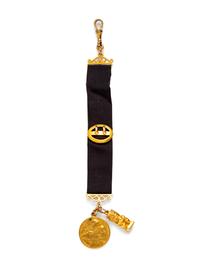 A Yellow Gold Fob with Attached Charms,