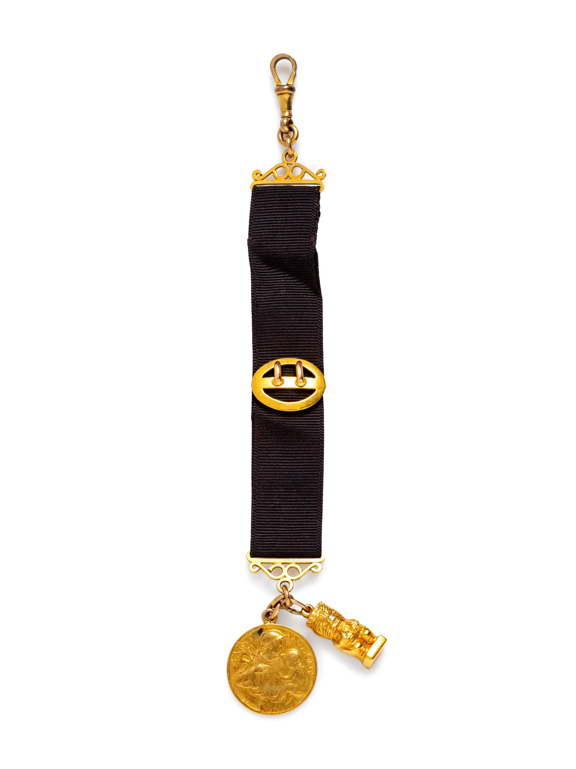 A Yellow Gold Fob with Attached Charms,