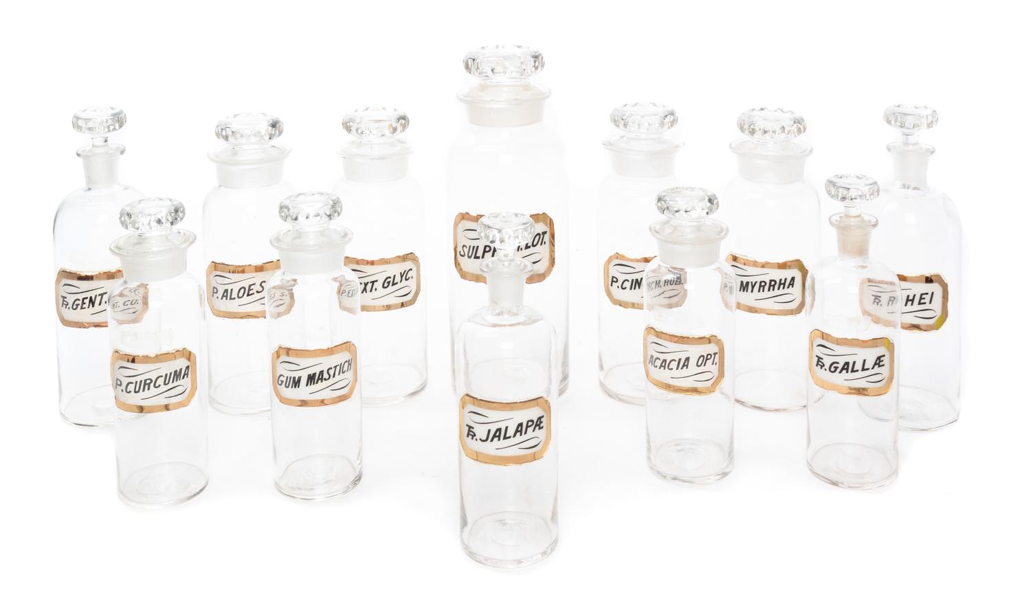A Set of Twelve Glass Apothecary Bottles Height of tallest 12 1/2 inches.