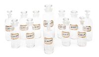A Set of Twelve Glass Apothecary Bottles Height of tallest 12 1/2 inches.