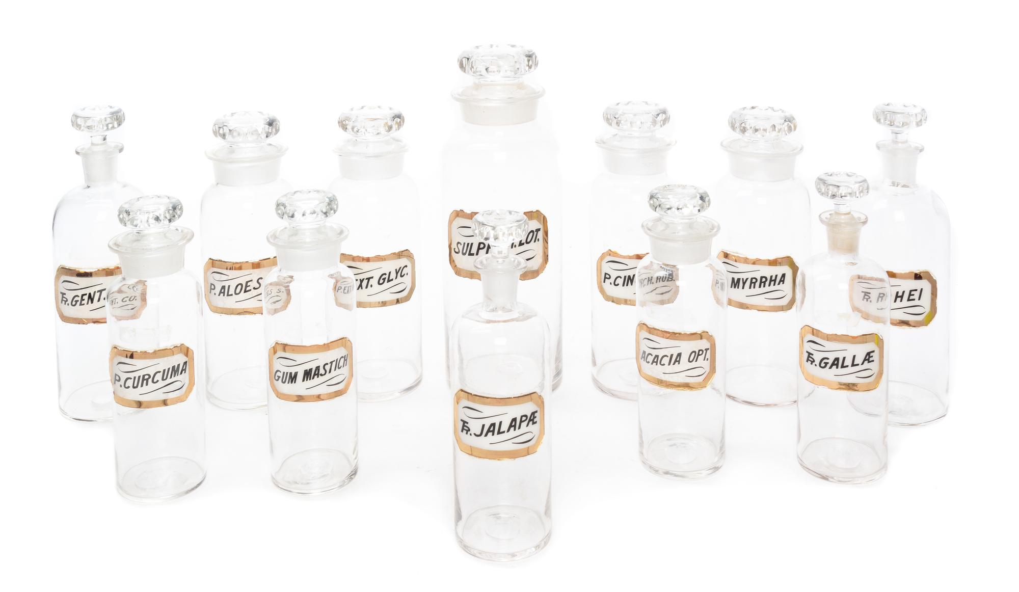 A Set of Twelve Glass Apothecary Bottles Height of tallest 12 1/2 inches.