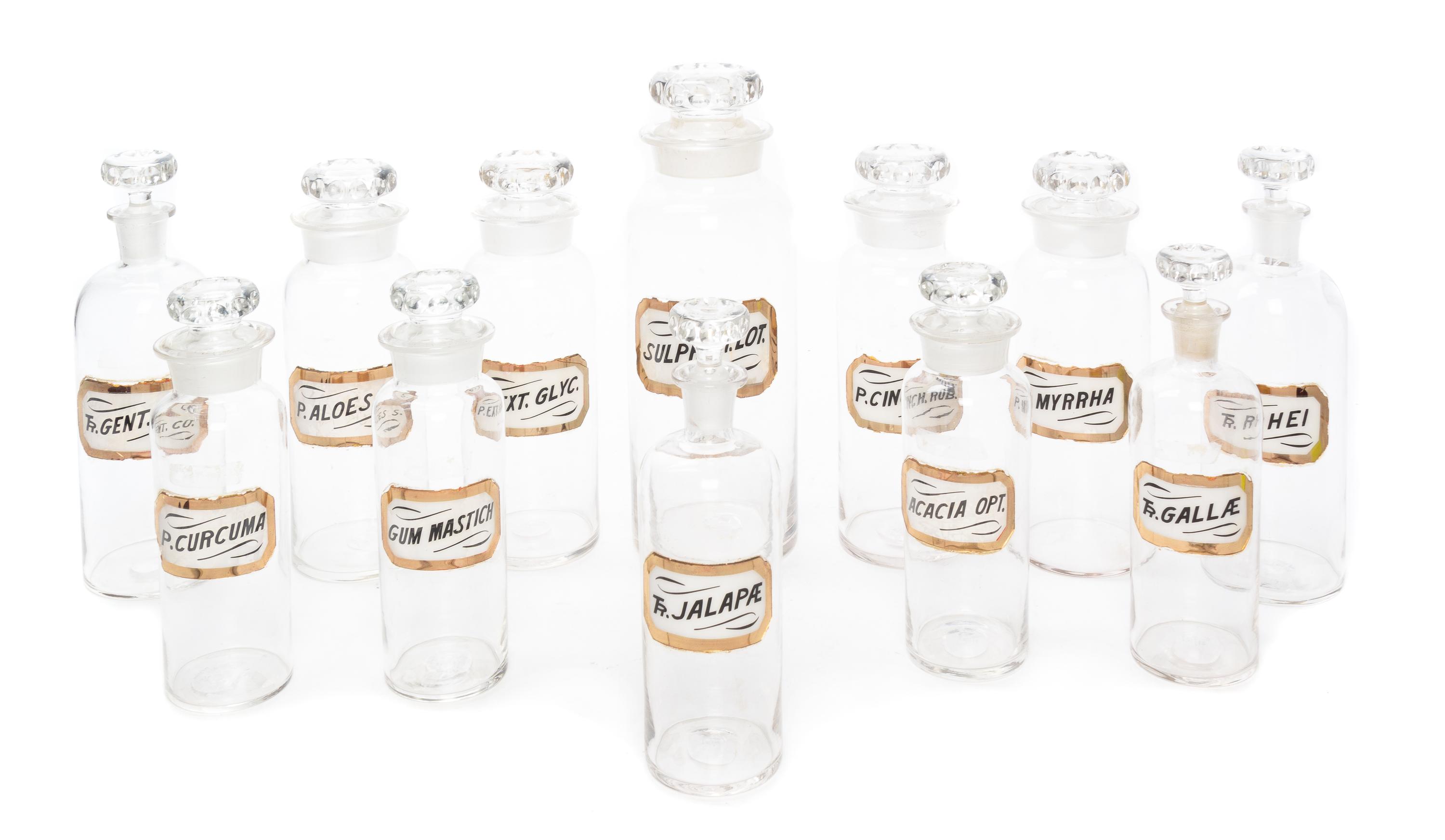 A Set of Twelve Glass Apothecary Bottles Height of tallest 12 1/2 inches.