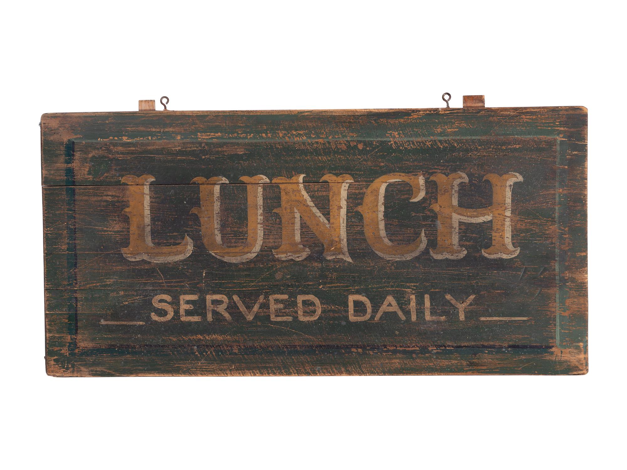 A 'Lunch Served Daily' Painted Wooden Sign