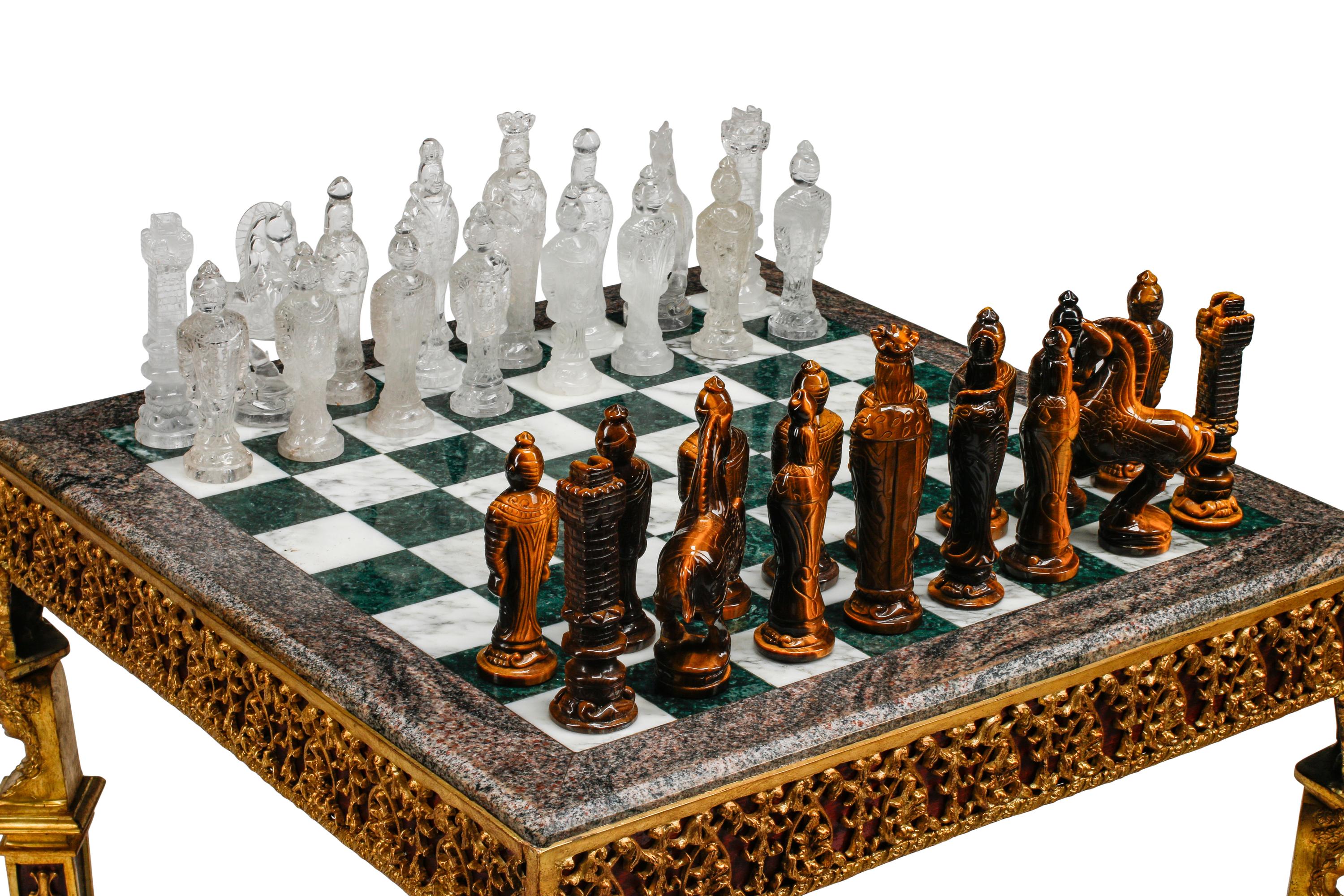An Empire Style Gilt Bronze Mounted Mahogany and Marble-Top Game Table with a Rock Crystal and Tiger's Eye Chess Set