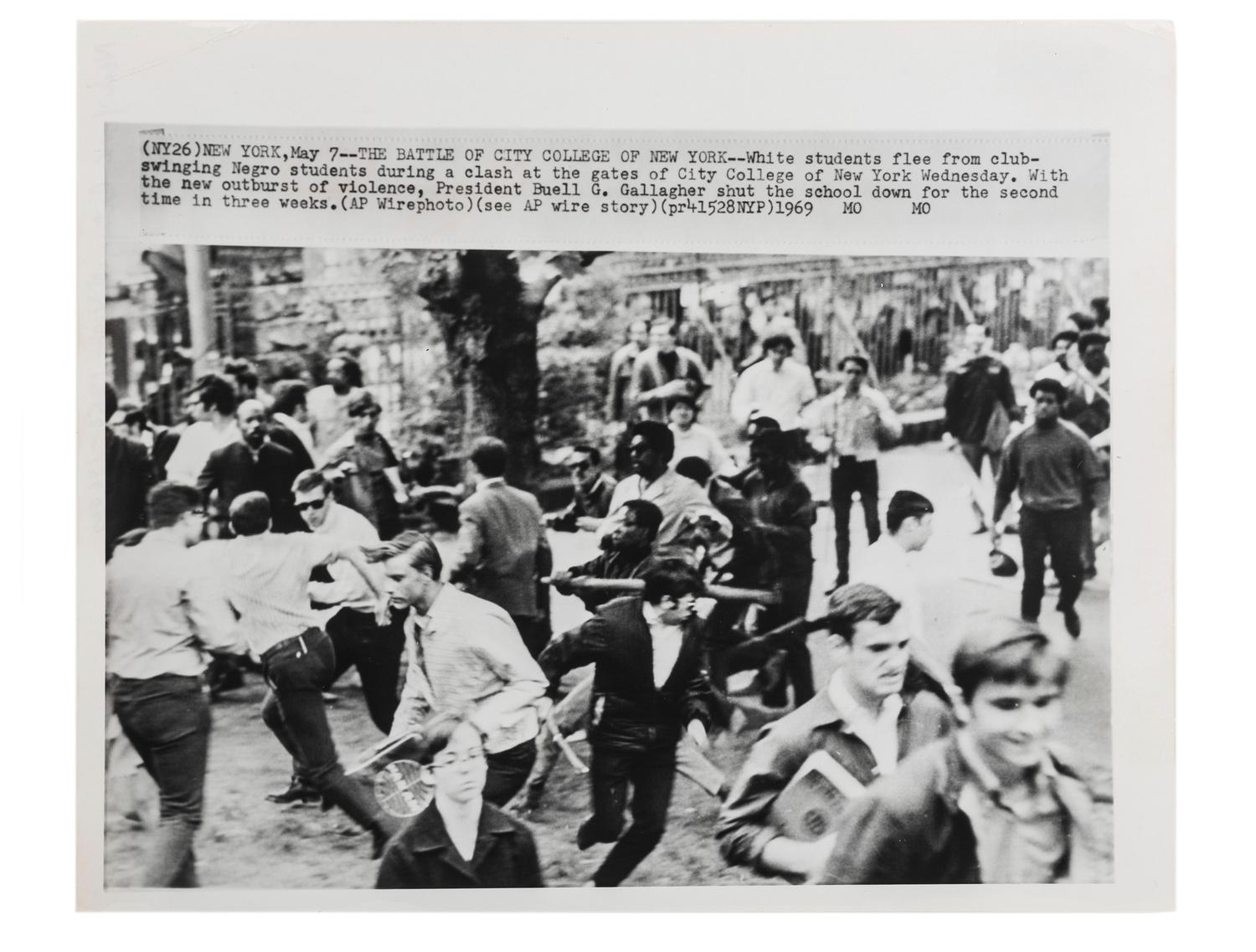 [CIVIL RIGHTS]. Press photograph capturing a clash between African American and white students at the gates of City College of New York. May 1969.