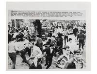 [CIVIL RIGHTS]. Press photograph capturing a clash between African American and white students at the gates of City College of New York. May 1969.